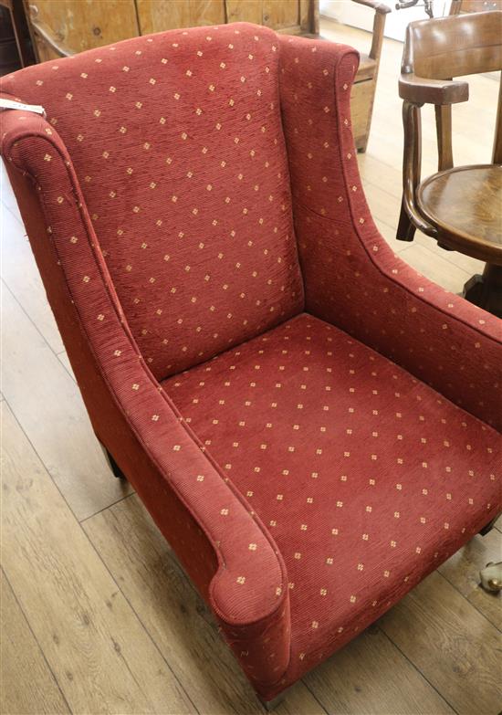 An upholstered wingback armchair